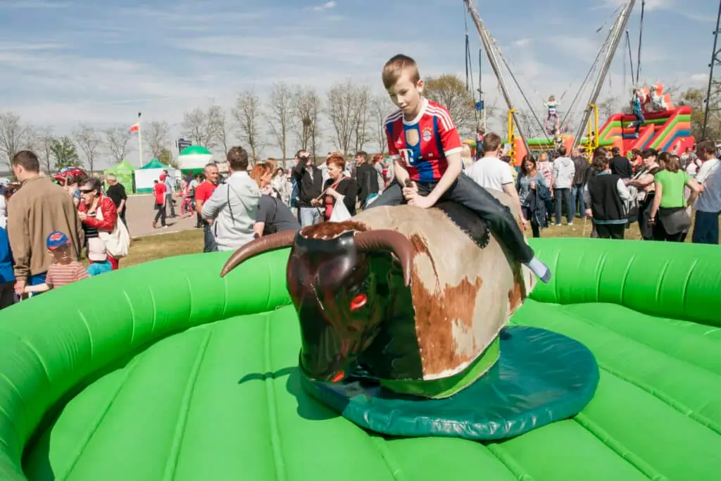 Chrzypsko, Poland - May 03, 2015: Unidentified boy playing bull riding toy